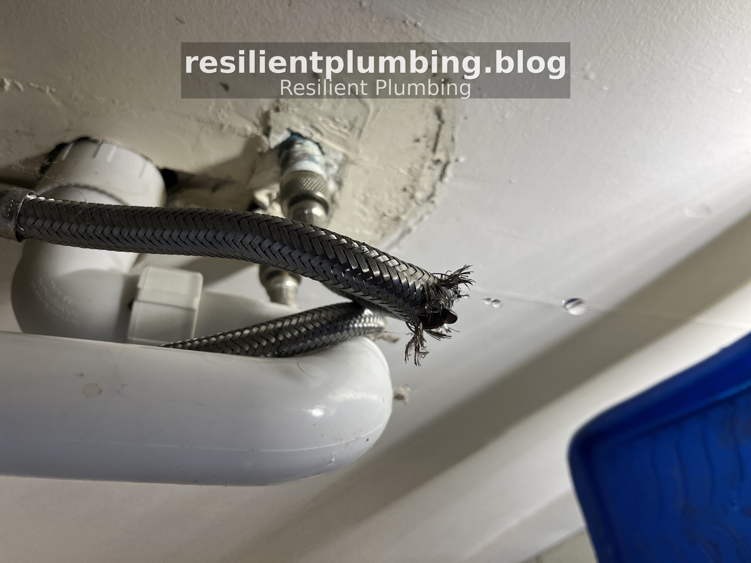 Braided stainless steel flexible hose under kitchen sink in Melbourne home