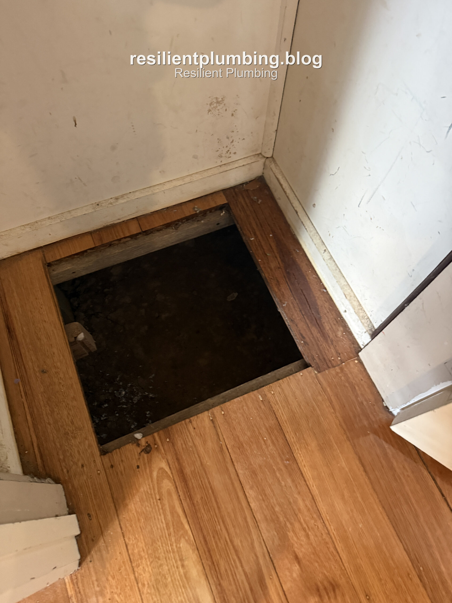 Existing subfloor access panel opening in timber flooring