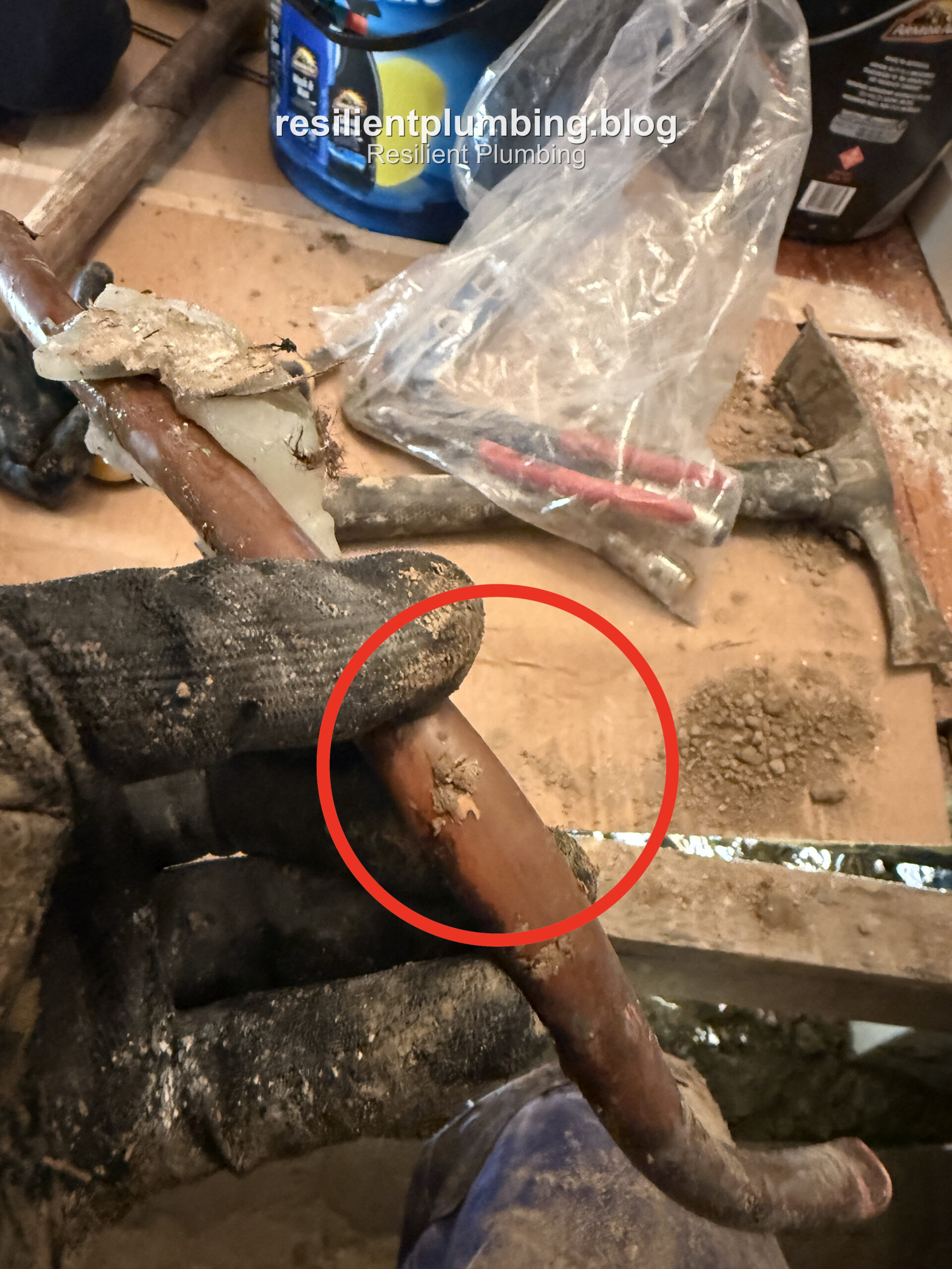 Close-up of the corroded, split copper pipe that caused the leak